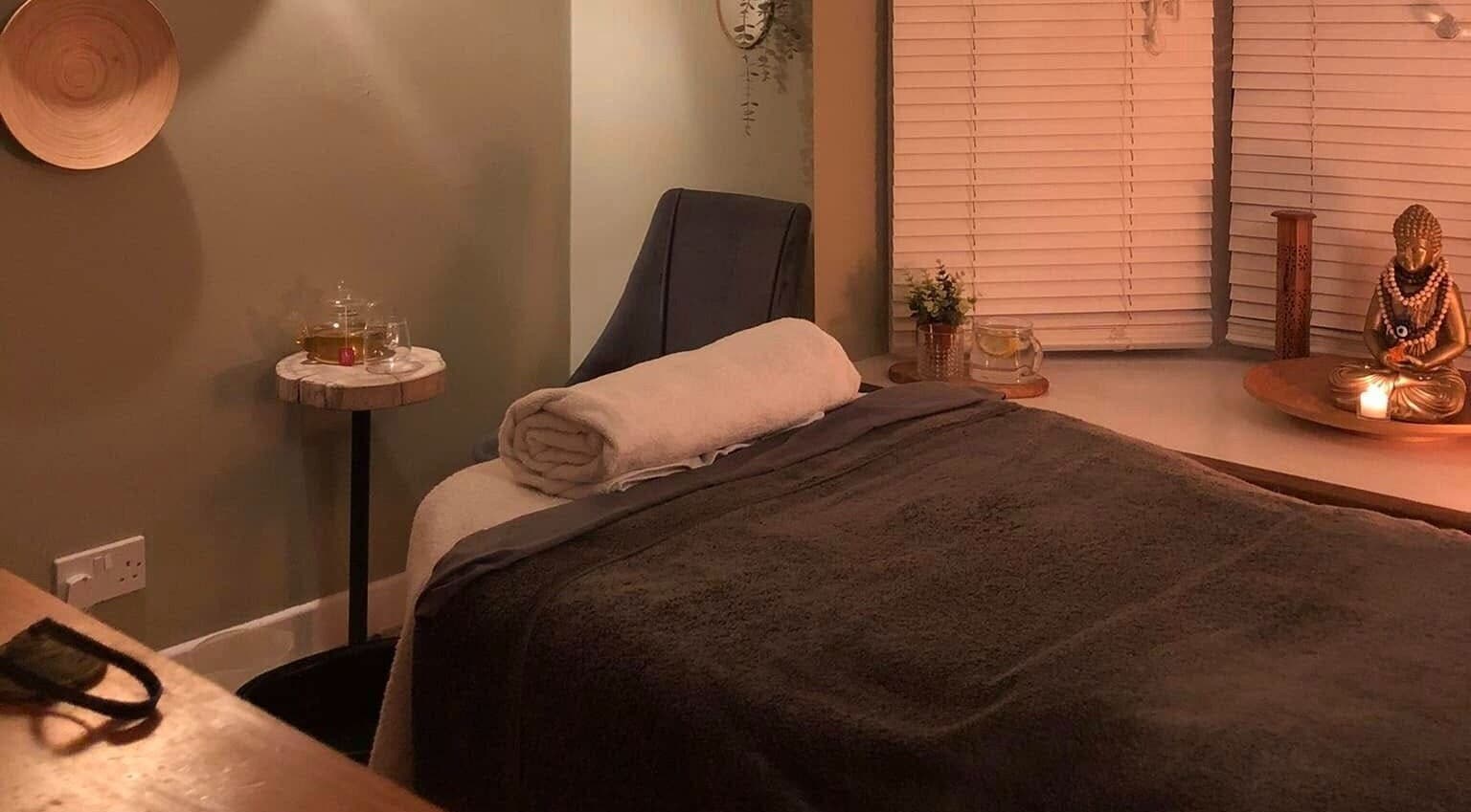 Cozy massage room at Apple Lodge Therapies, Redditch, England, GB, with a massage bed, candlelight, and tranquil decor.