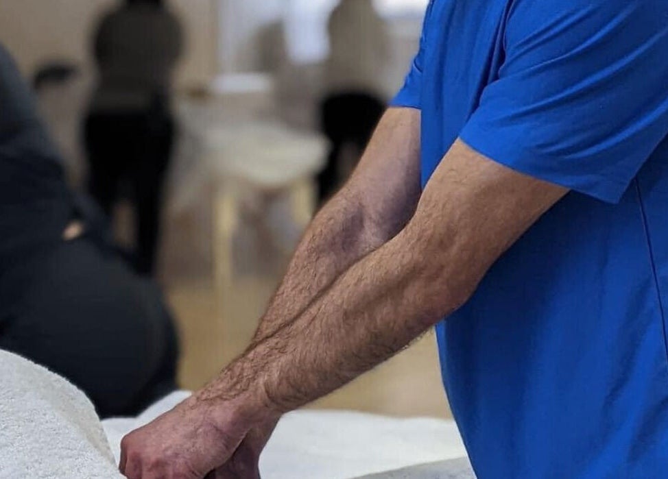 Therapist providing massage at Apple Lodge Therapies, Redditch, England, GB. Relaxing wellness session.