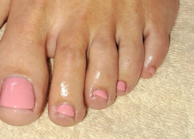 Pink pedicure at B Beautiful Birmingham at Endres, Birmingham, England, GB enhancing feet on towel.