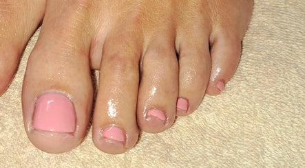 Pink pedicure at B Beautiful Birmingham at Endres, Birmingham, England, GB enhancing feet on towel.