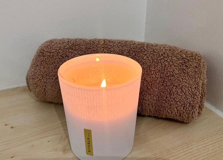 Lit candle and rolled towel at B Beautiful Birmingham at Endres, Birmingham, England, GB enhance spa tranquility.
