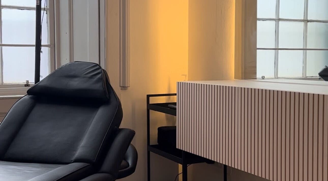 Cozy treatment room at Justdemi., House of Naf! in Glasgow, Scotland, GB with a plush black chair.