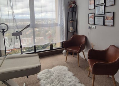 Relaxing treatment room at The Slimming Lounge, Parramatta, New South Wales, AU, with a view and cozy seating.