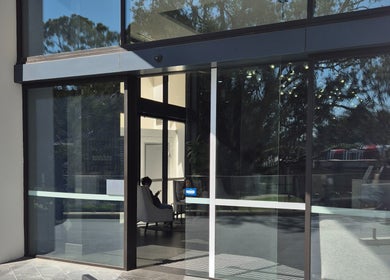Glass entrance of The Slimming Lounge, Parramatta, New South Wales, AU, showcasing a modern waiting area.