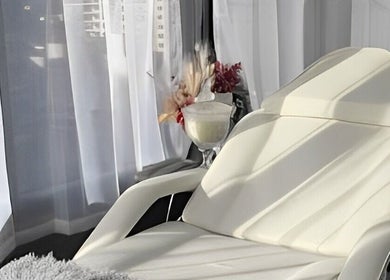 Elegant white lounge chair in sunlight at The Slimming Lounge, Parramatta, New South Wales, AU.