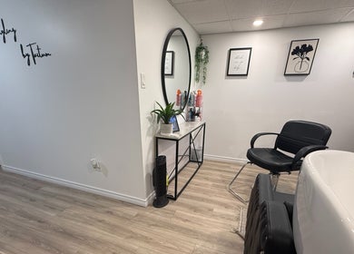 Chic salon interior at Hairstyling by Taitum, Renfrew, Ontario, CA featuring stylish decor and modern furnishings.