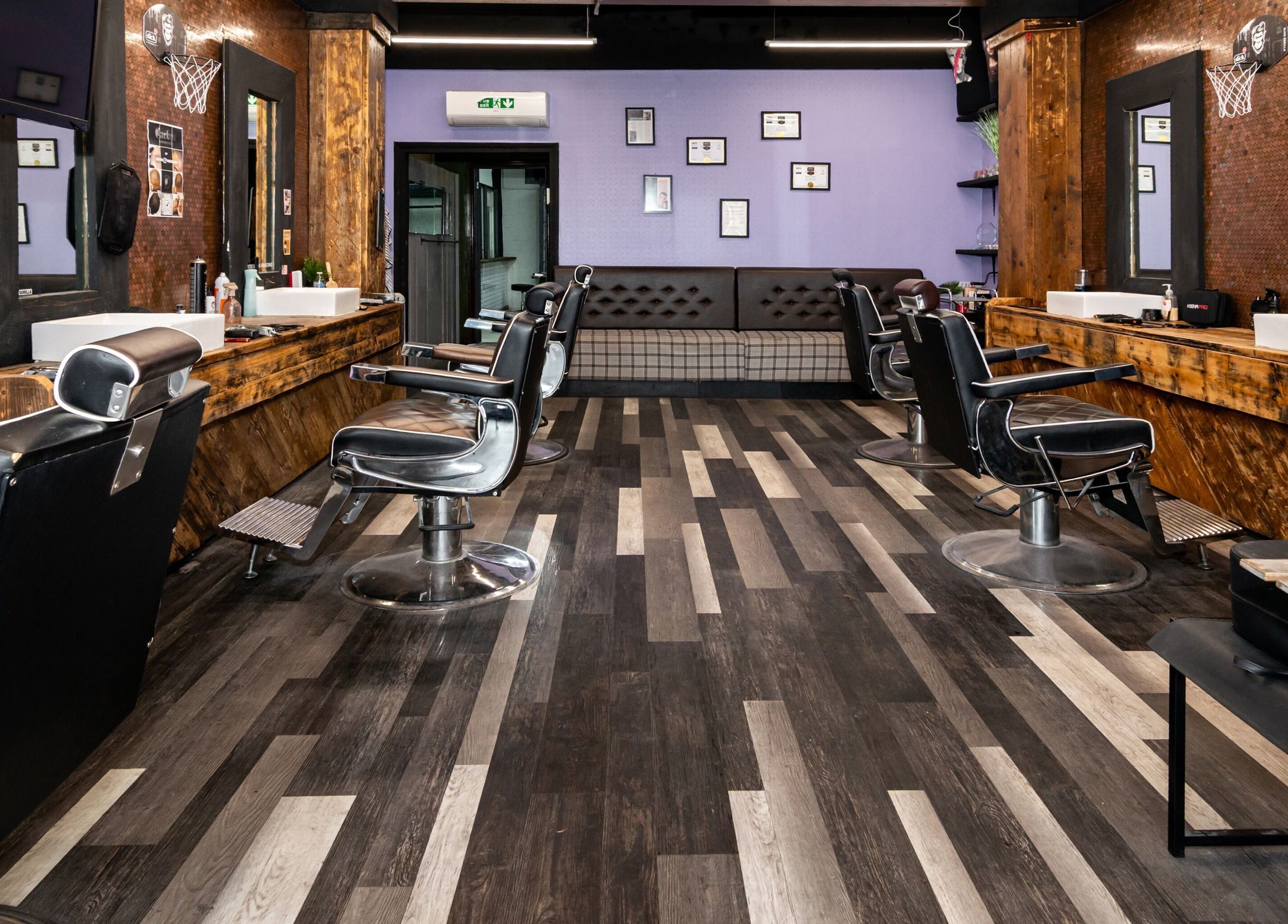 Interior of Skins & Needles Barbers, Middlesbrough, England, featuring modern barber chairs and rustic decor.