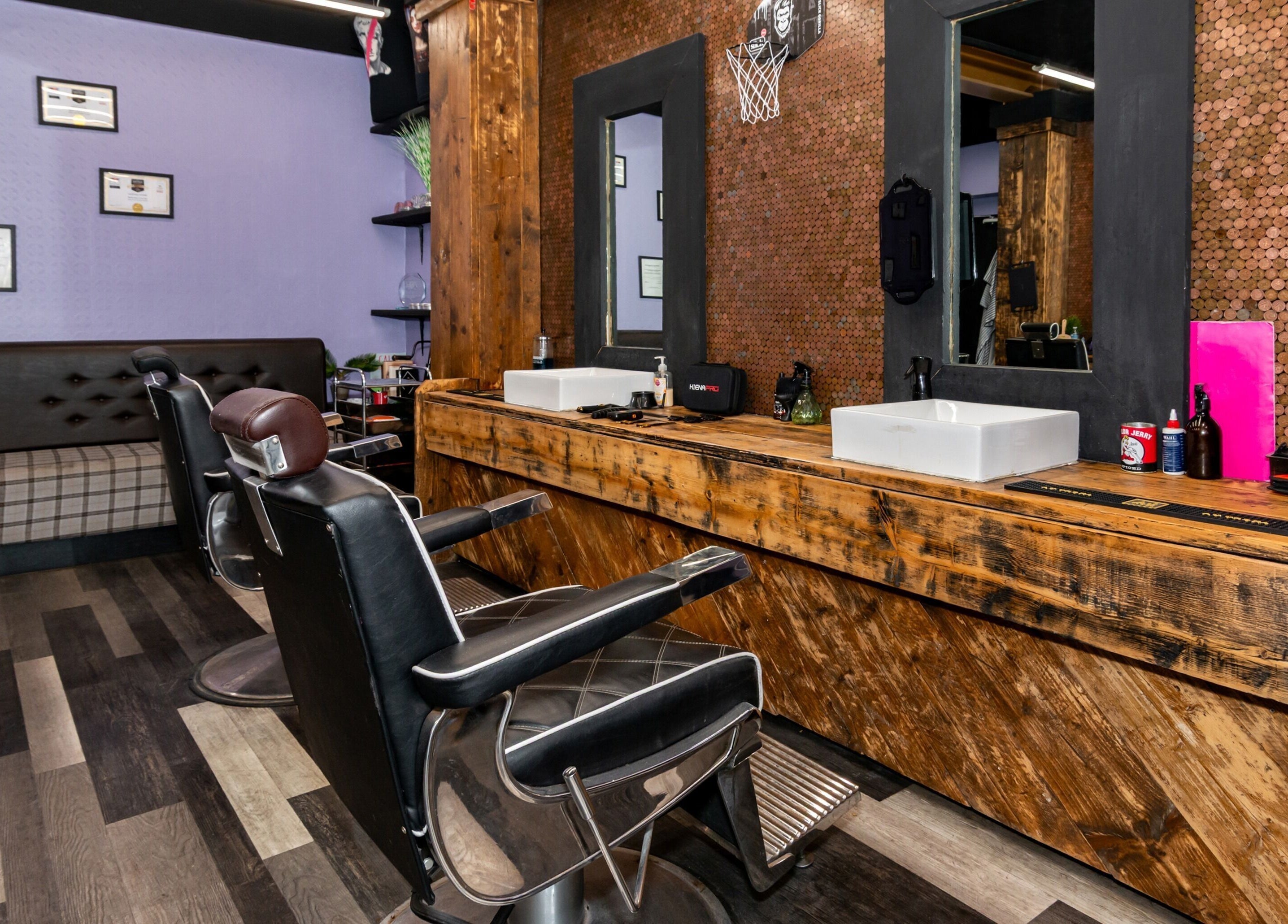 Interior of Skins & Needles Barbers in Middlesbrough, England, GB featuring stylish barber chairs and wooden decor.