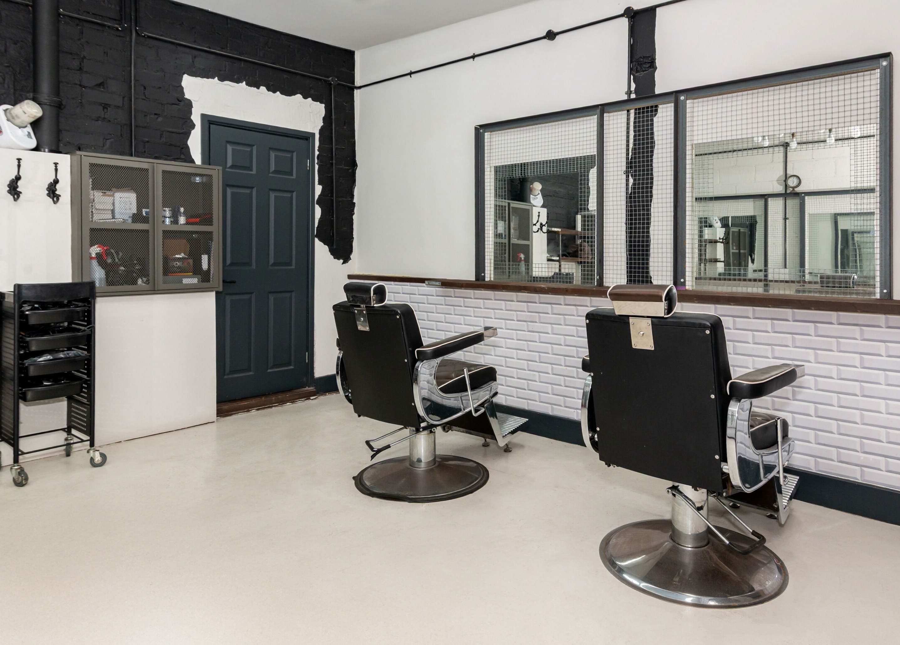 Interior of Skins & Needles Barbers in Middlesbrough, England, GB showcasing stylish barber chairs and modern decor.