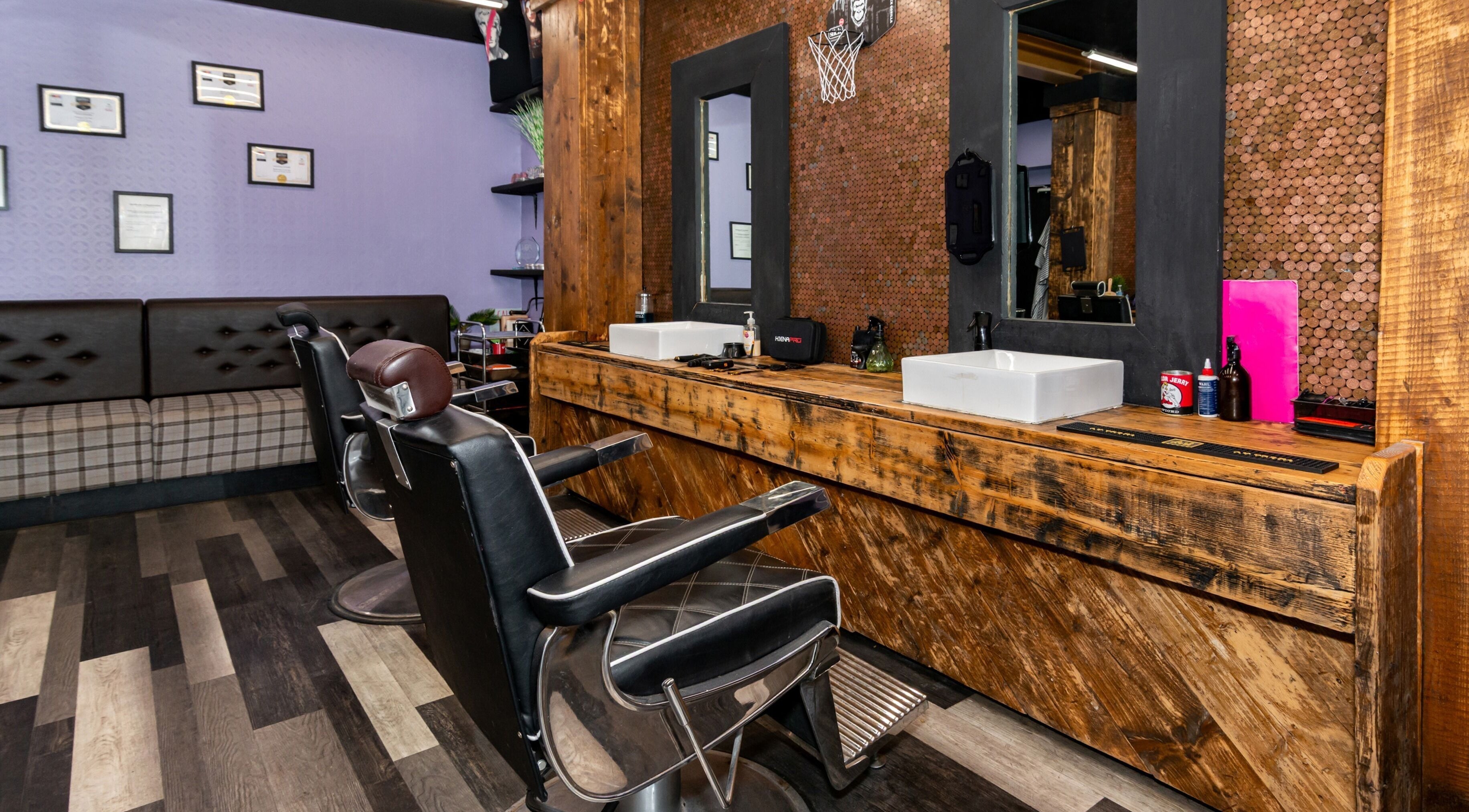 Chic barber chairs and wooden counters at Skins & Needles Barbers, Middlesbrough, England, GB.