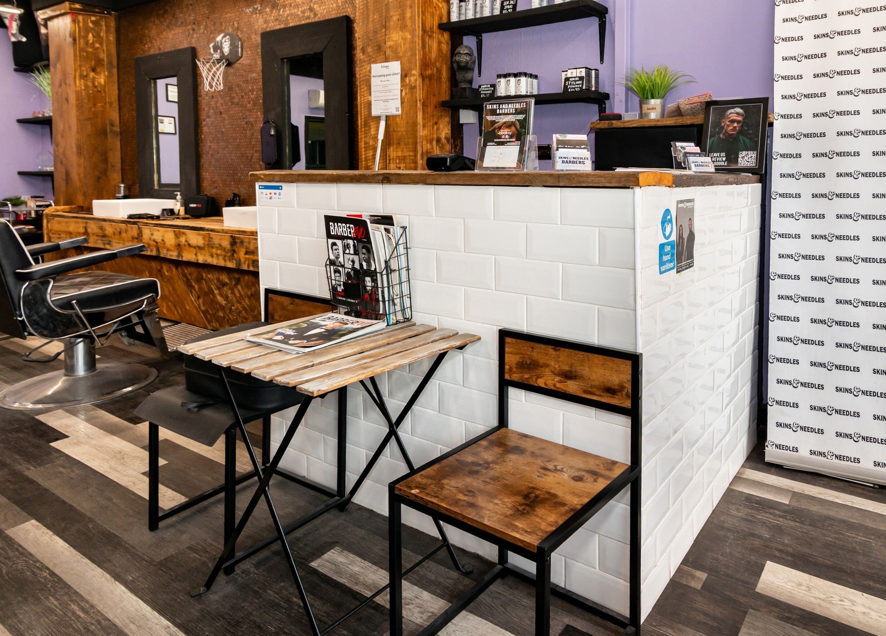Interior of Skins & Needles Barbers in Middlesbrough, England, GB featuring stylish chairs and modern decor.