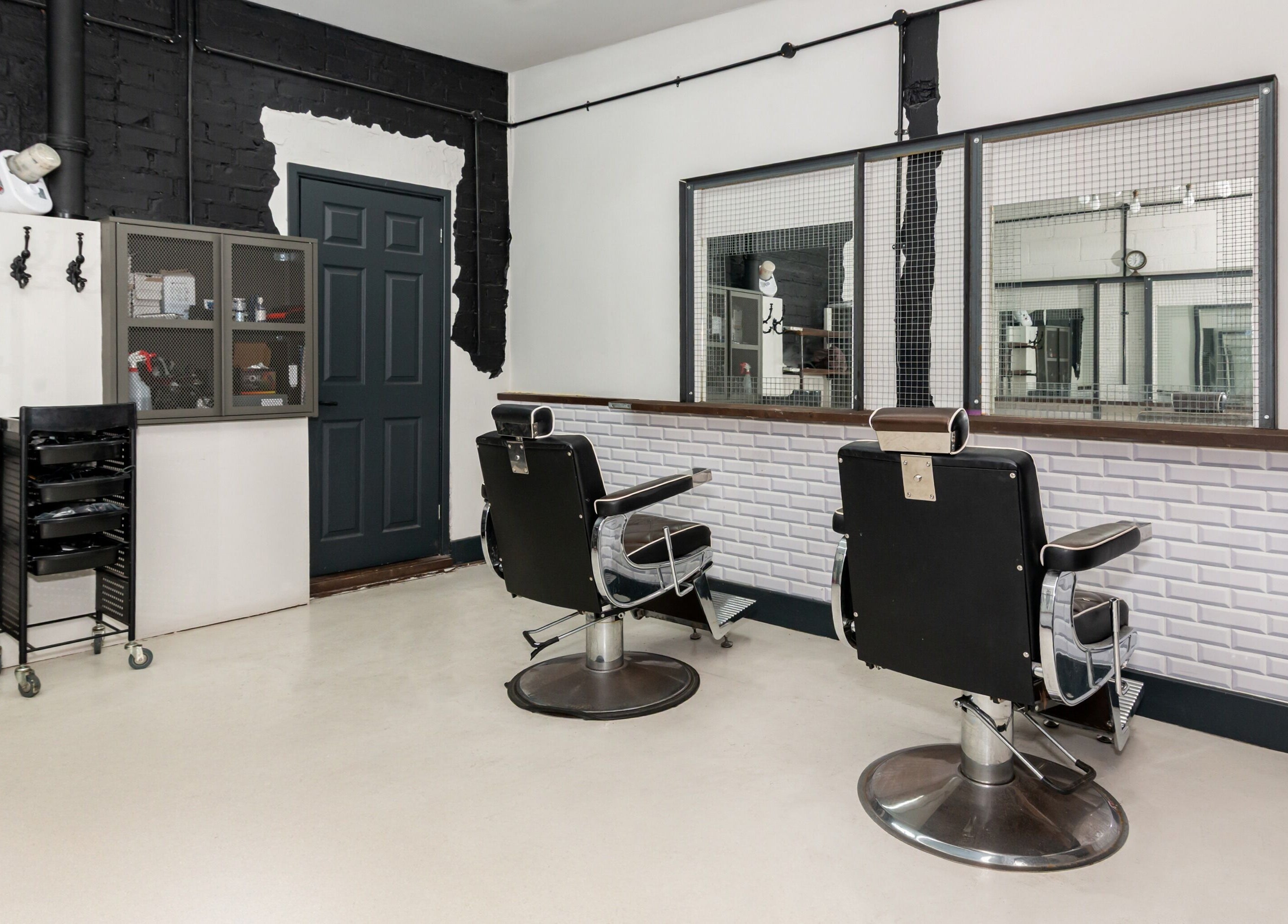 Interior of Skins & Needles Barbers in Middlesbrough, England, featuring stylish barber chairs and modern decor.