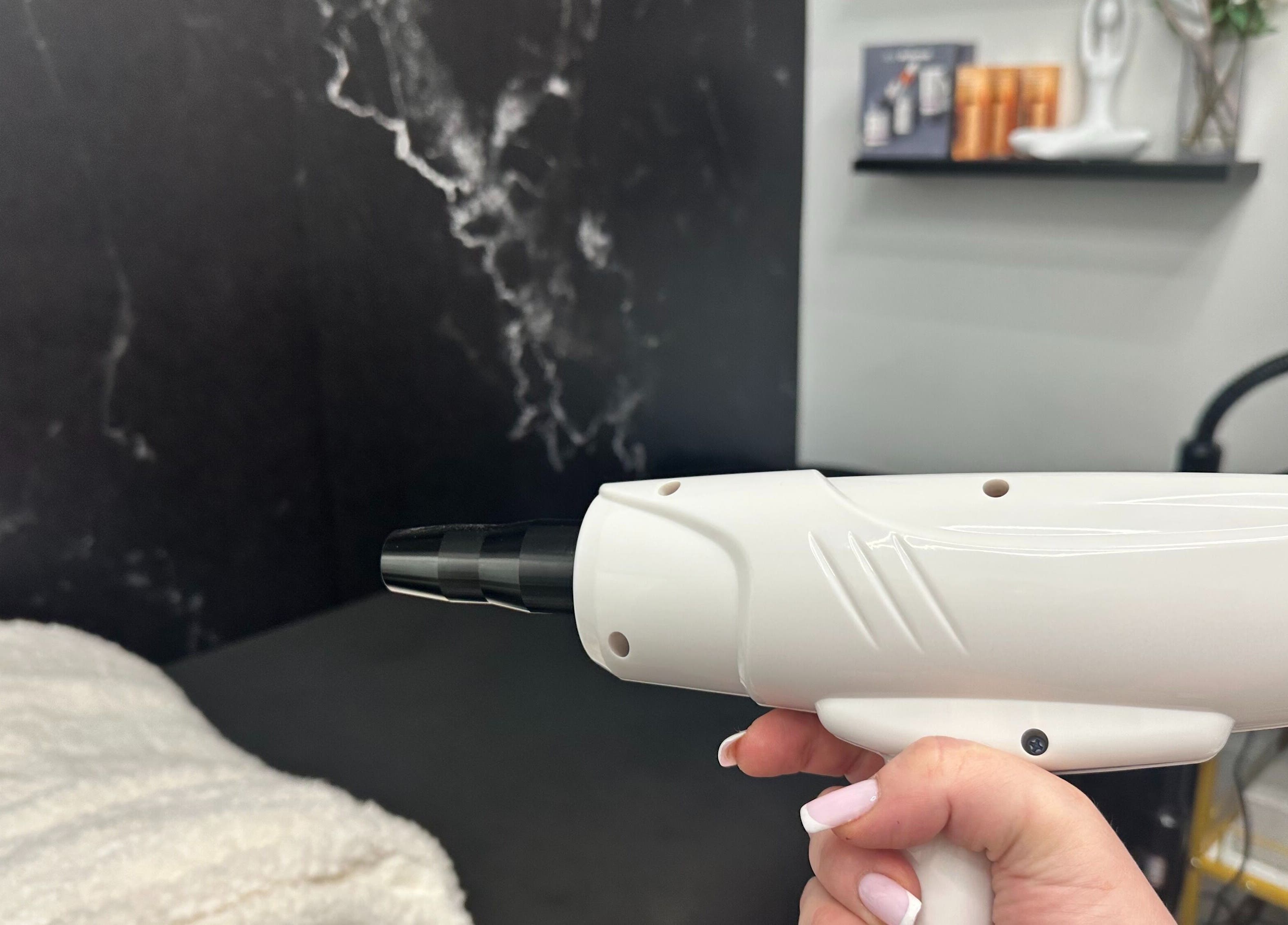 Close-up of laser treatment device at ELEVATE, Bellmore, New York, US. Luxurious spa ambiance.