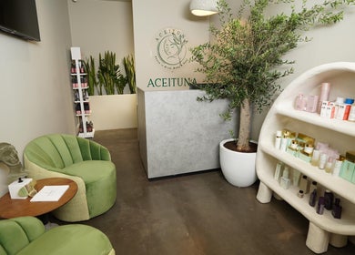 Aceituna Beauty Salon L.L.C reception area with modern decor and lush plants in Dubai, Dubai, AE.