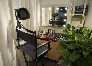 Makeup station with chair at Aceituna Beauty Salon L.L.C, Dubai, Dubai, AE featuring plants and mirror lighting.