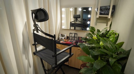 Makeup station with chair at Aceituna Beauty Salon L.L.C, Dubai, Dubai, AE featuring plants and mirror lighting.