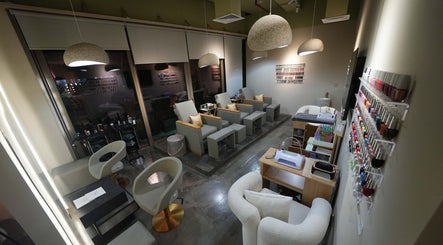 Chic interior of Aceituna Beauty Salon L.L.C in Dubai, Dubai, AE with modern seating and nail polish display.