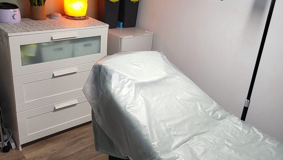 Cozy treatment room at By Donna in Doncaster, England, GB, featuring a softly lit bed and a warm ambiance.