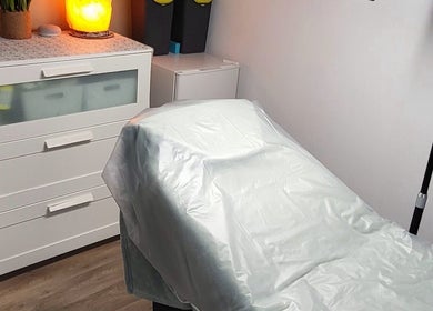 Cozy treatment room at By Donna in Doncaster, England, GB, featuring a softly lit bed and a warm ambiance.