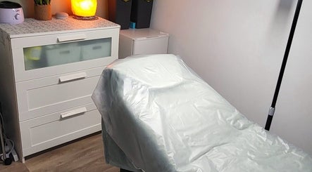 Cozy treatment room at By Donna in Doncaster, England, GB, featuring a softly lit bed and a warm ambiance.