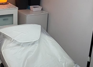 Peaceful treatment room at By Donna, Doncaster, England, GB with a warm-lit lamp.