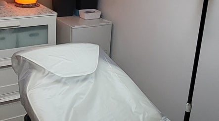 Peaceful treatment room at By Donna, Doncaster, England, GB with a warm-lit lamp.