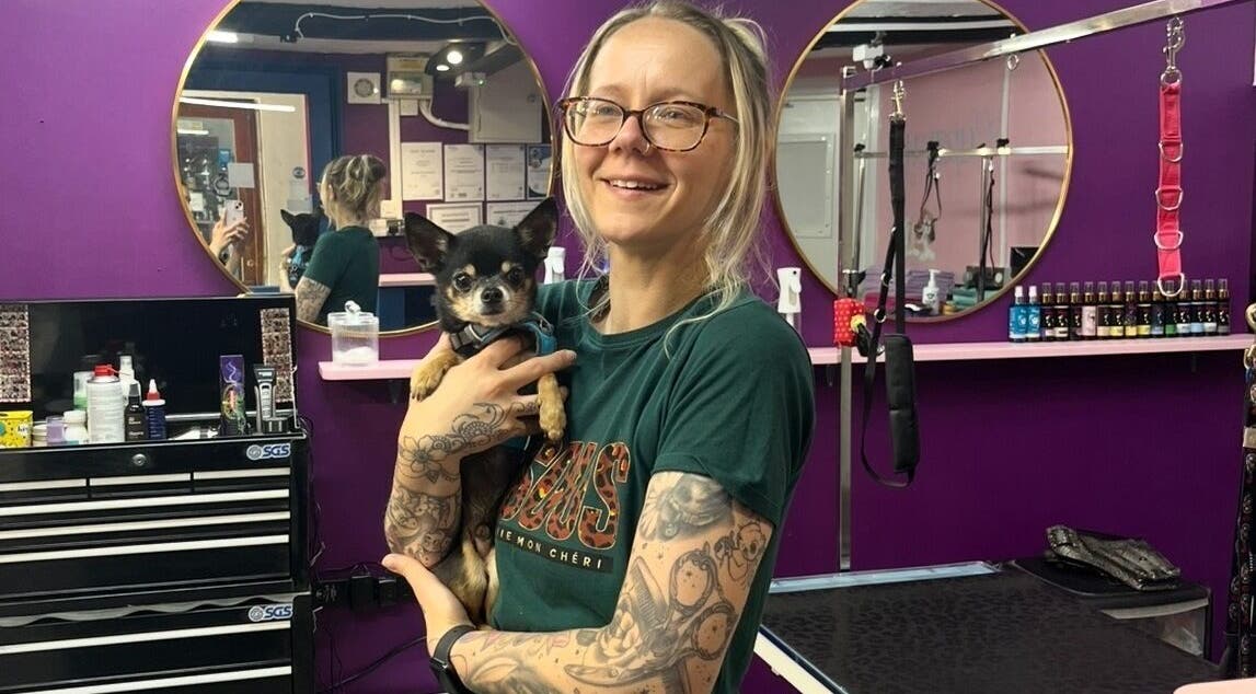 Happy groomer with a Chihuahua at Pup Suey Dog Grooming in Devizes, England, GB.