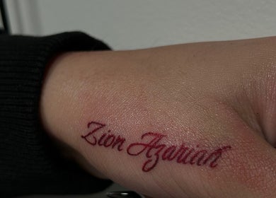 Elegant tattoo lettering on hand at Inked n' Lashed, Oakville, Ontario, CA.