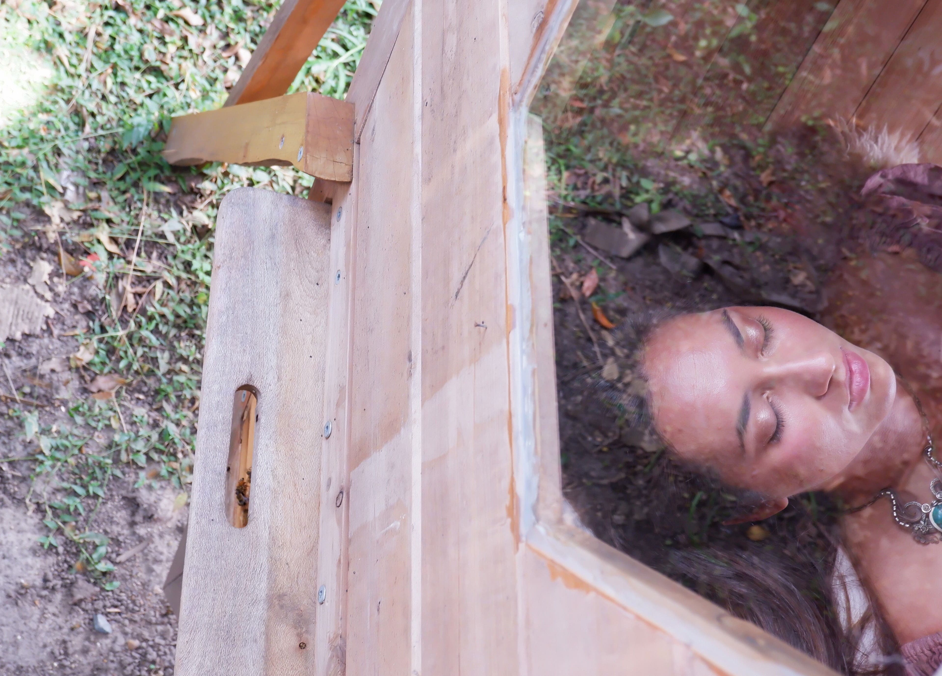 A serene woman relaxing in a wooden sanctuary at Bee Alive, Mullumbimby, New South Wales, AU.