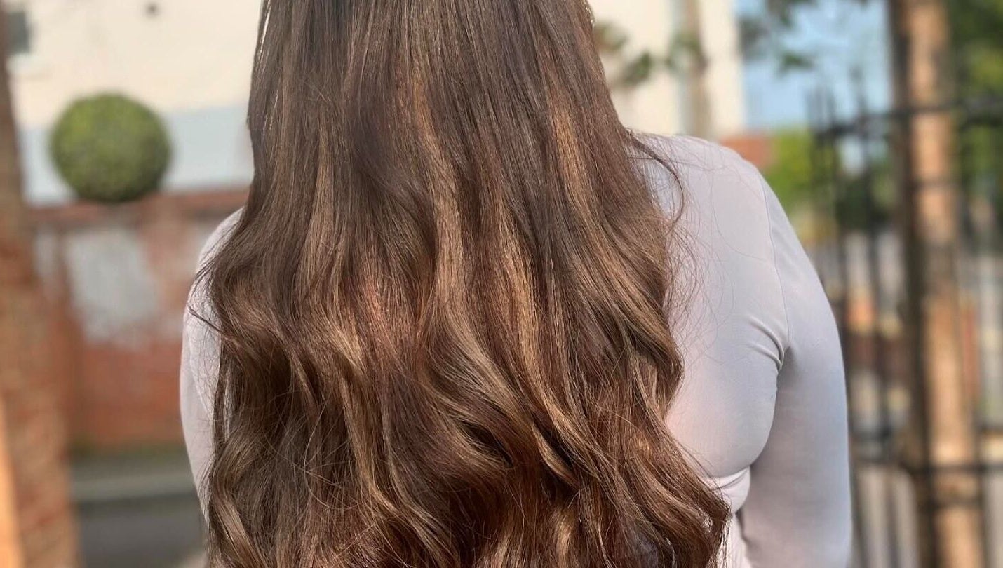 Long, wavy brown hair styled at Salon 63 in Albrighton, England, GB. Smooth and shiny salon finish.