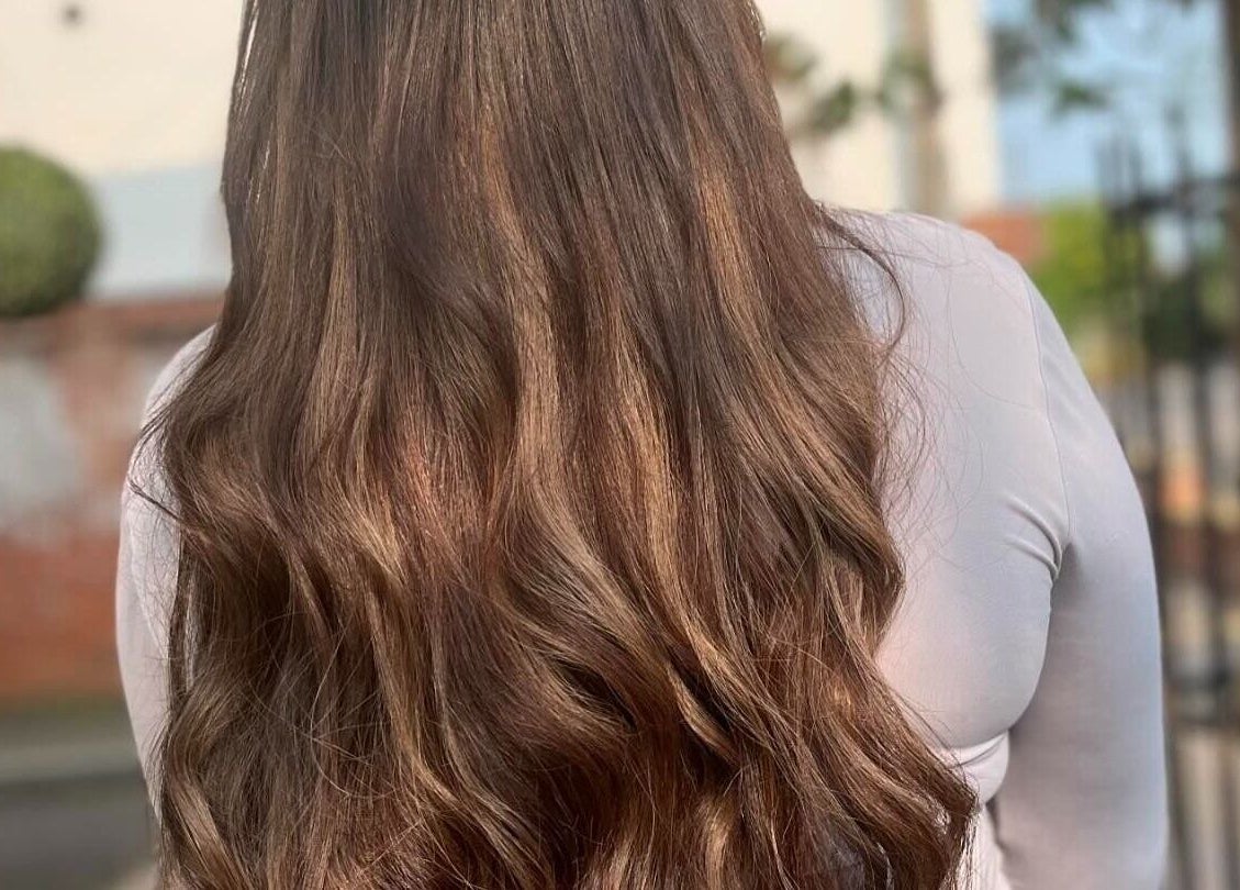 Long, wavy brown hair styled at Salon 63 in Albrighton, England, GB. Smooth and shiny salon finish.