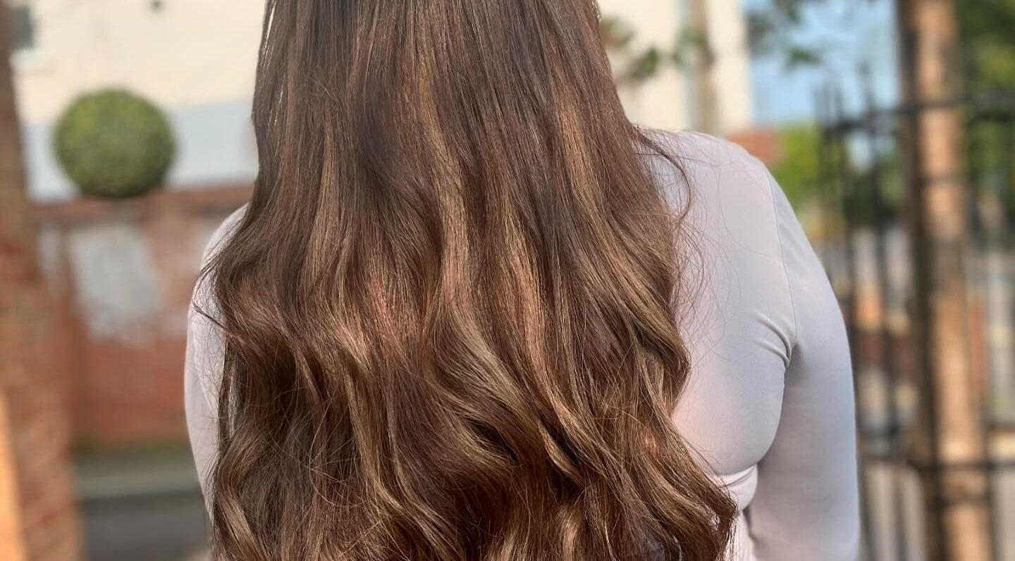Long, wavy brown hair styled at Salon 63 in Albrighton, England, GB. Smooth and shiny salon finish.