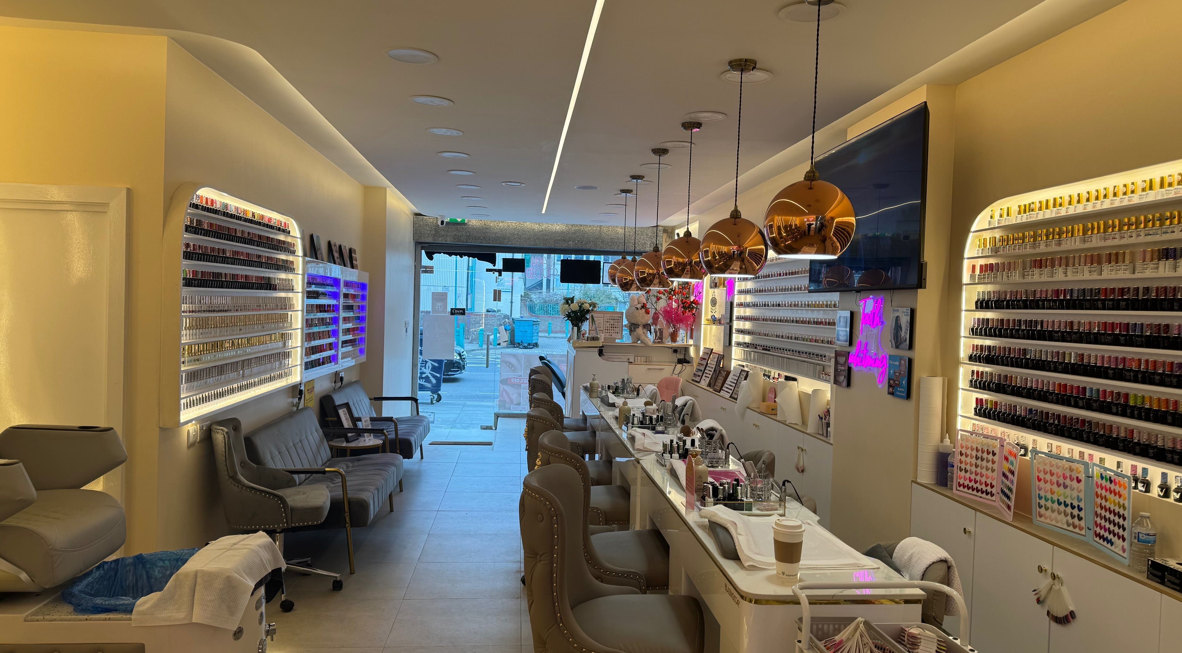 Interior of Paradise ‘N’ Beauty ltd, London, England, GB, showcasing elegant nail salon setup with vibrant decor.