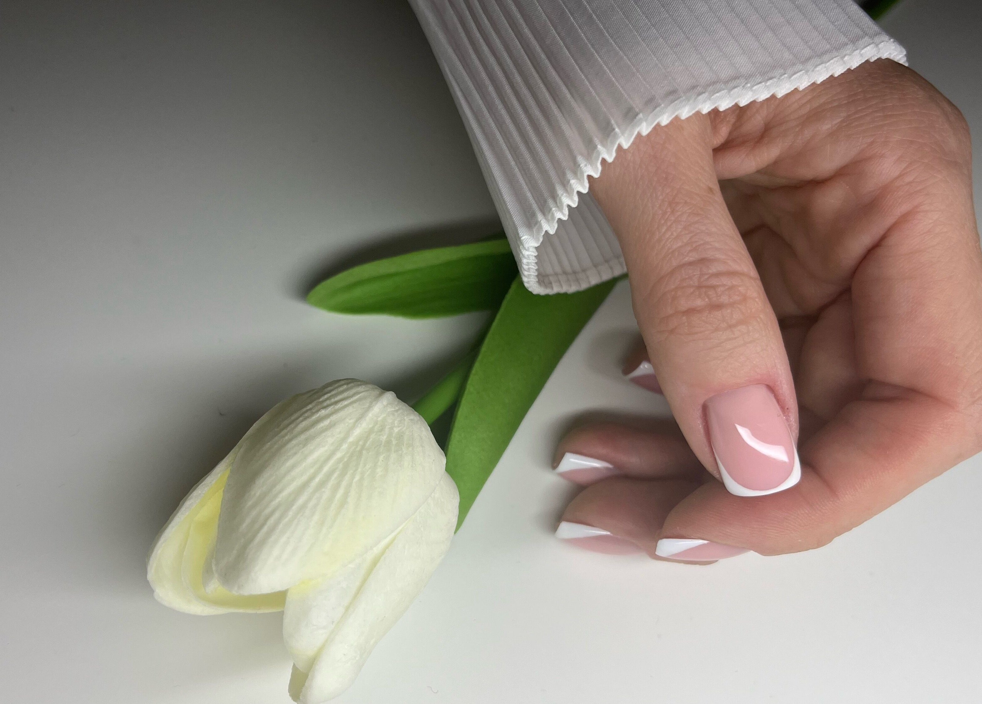 Elegant French manicure at Classy Nails & Brows, Celbridge, County Kildare, IE with a white tulip.