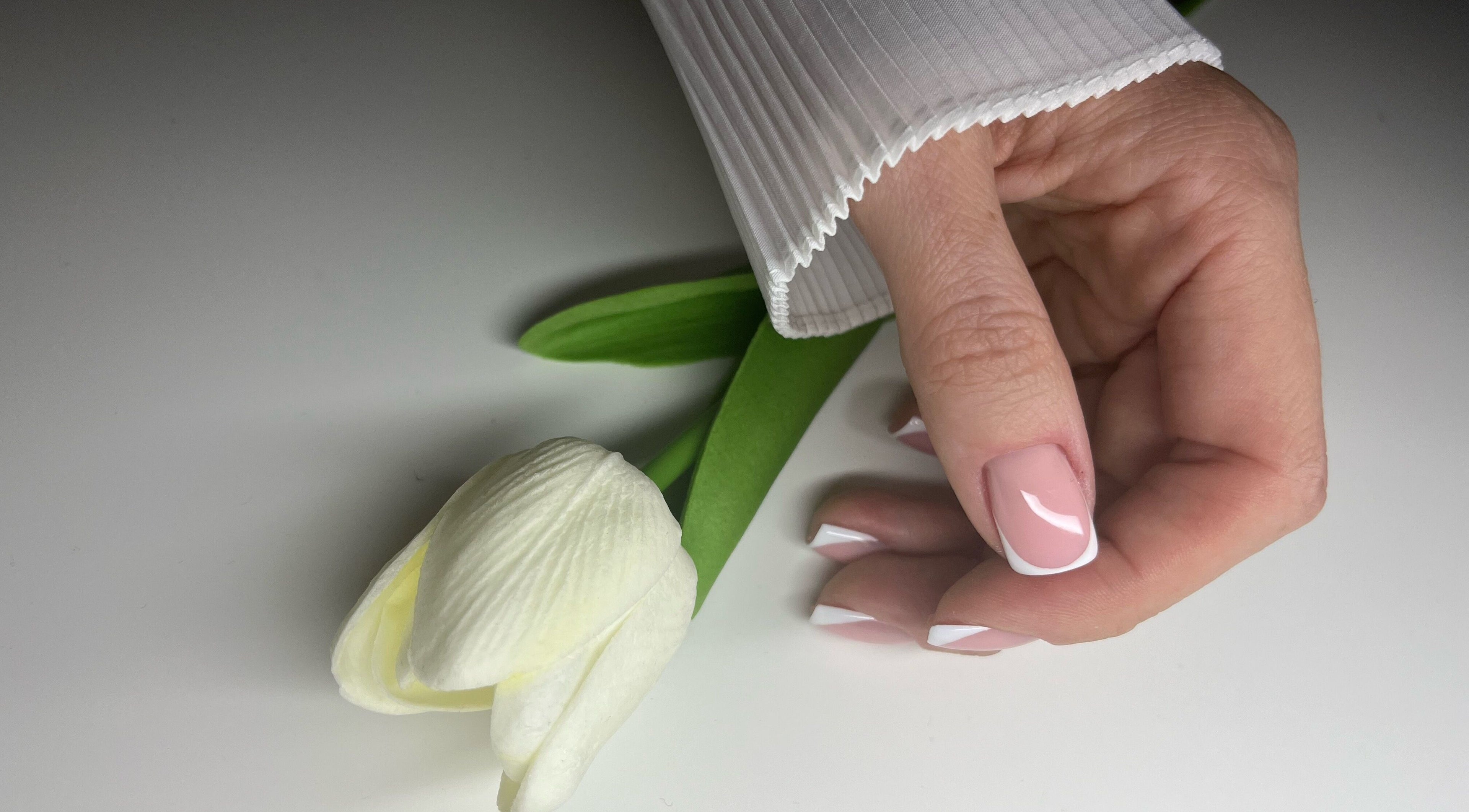 Elegant French manicure at Classy Nails & Brows, Celbridge, County Kildare, IE with a white tulip.