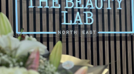 Stylish neon sign at The Beauty Lab North East South Shields, South Shields, England, GB with floral decor.