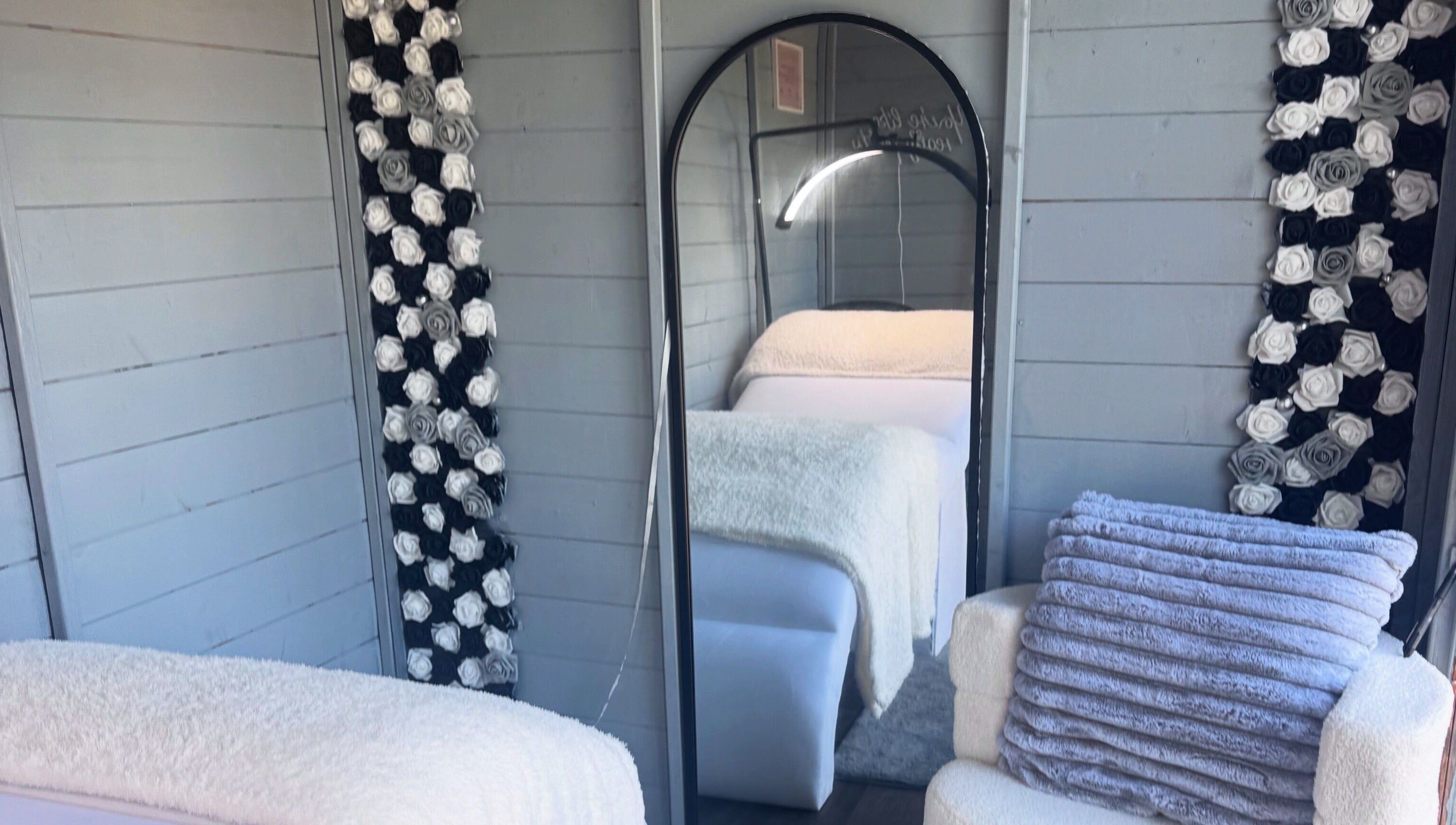 Cozy interior decor at Thelashlocus, Leeds, England, GB featuring plush textiles and elegant flower accents.