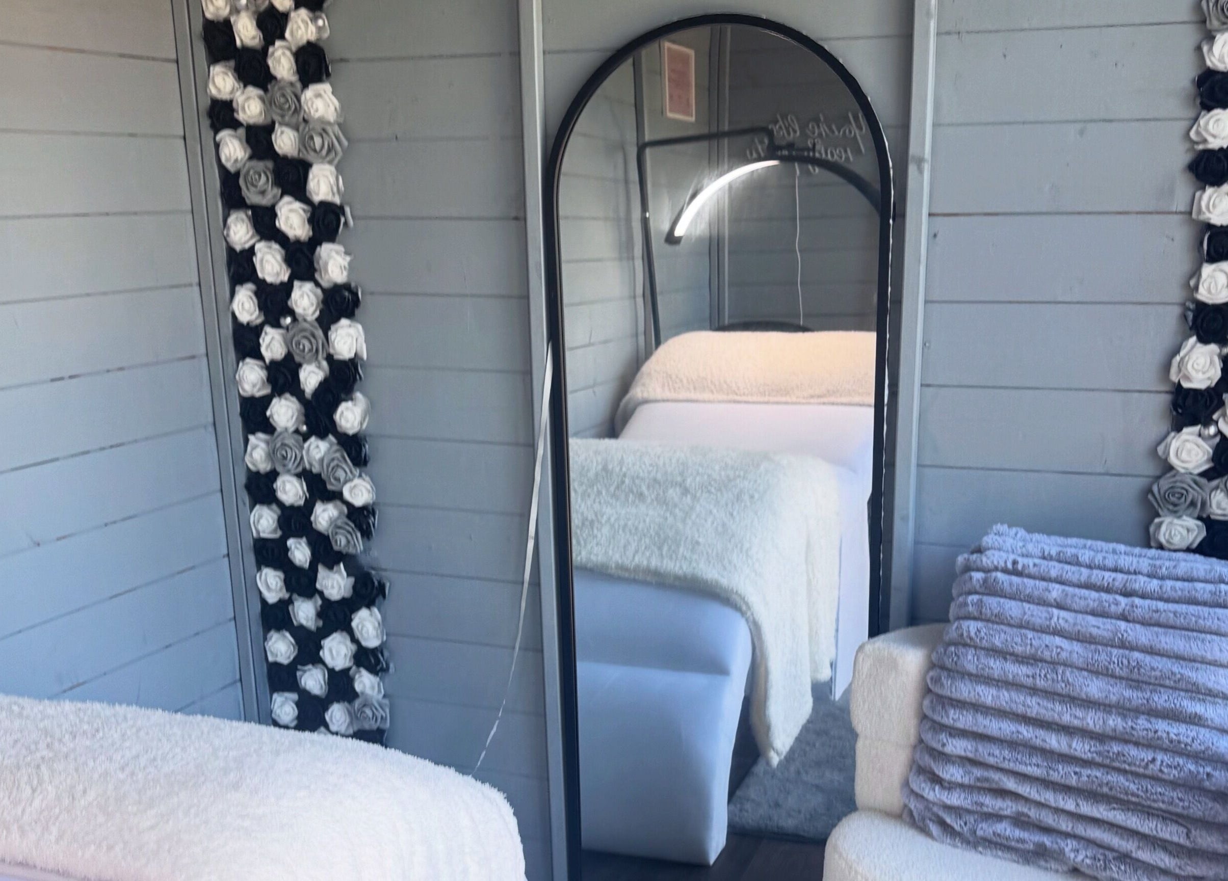 Cozy interior decor at Thelashlocus, Leeds, England, GB featuring plush textiles and elegant flower accents.