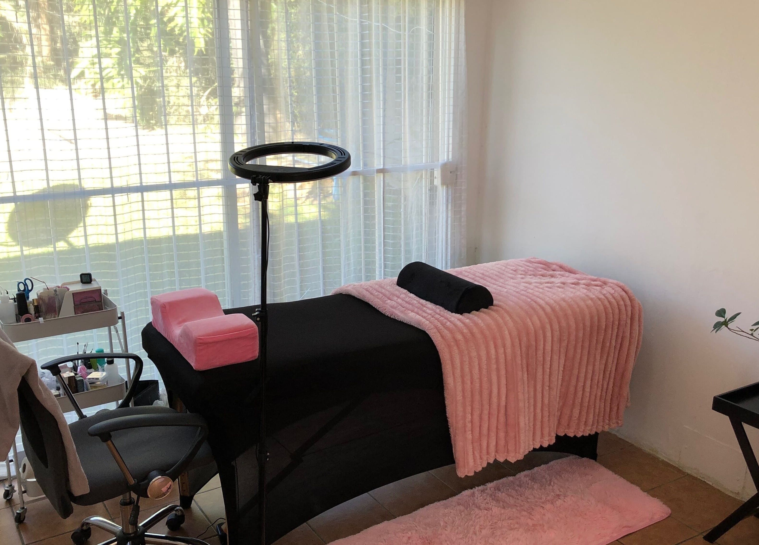 Cozy spa room at Altered Studio, Edenvale, Gauteng, ZA, featuring a massage table with pink accents in bright light.