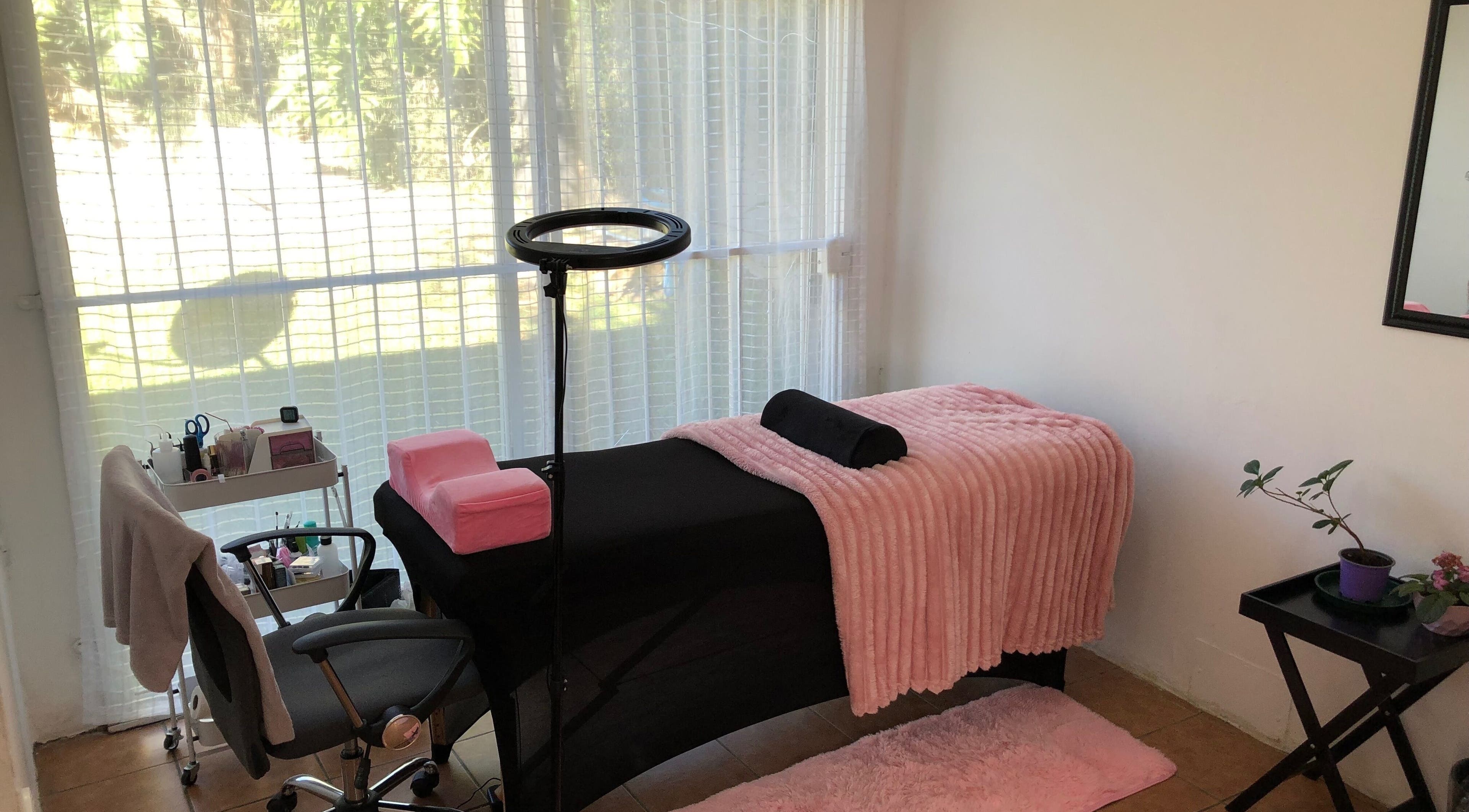 Cozy spa room at Altered Studio, Edenvale, Gauteng, ZA, featuring a massage table with pink accents in bright light.