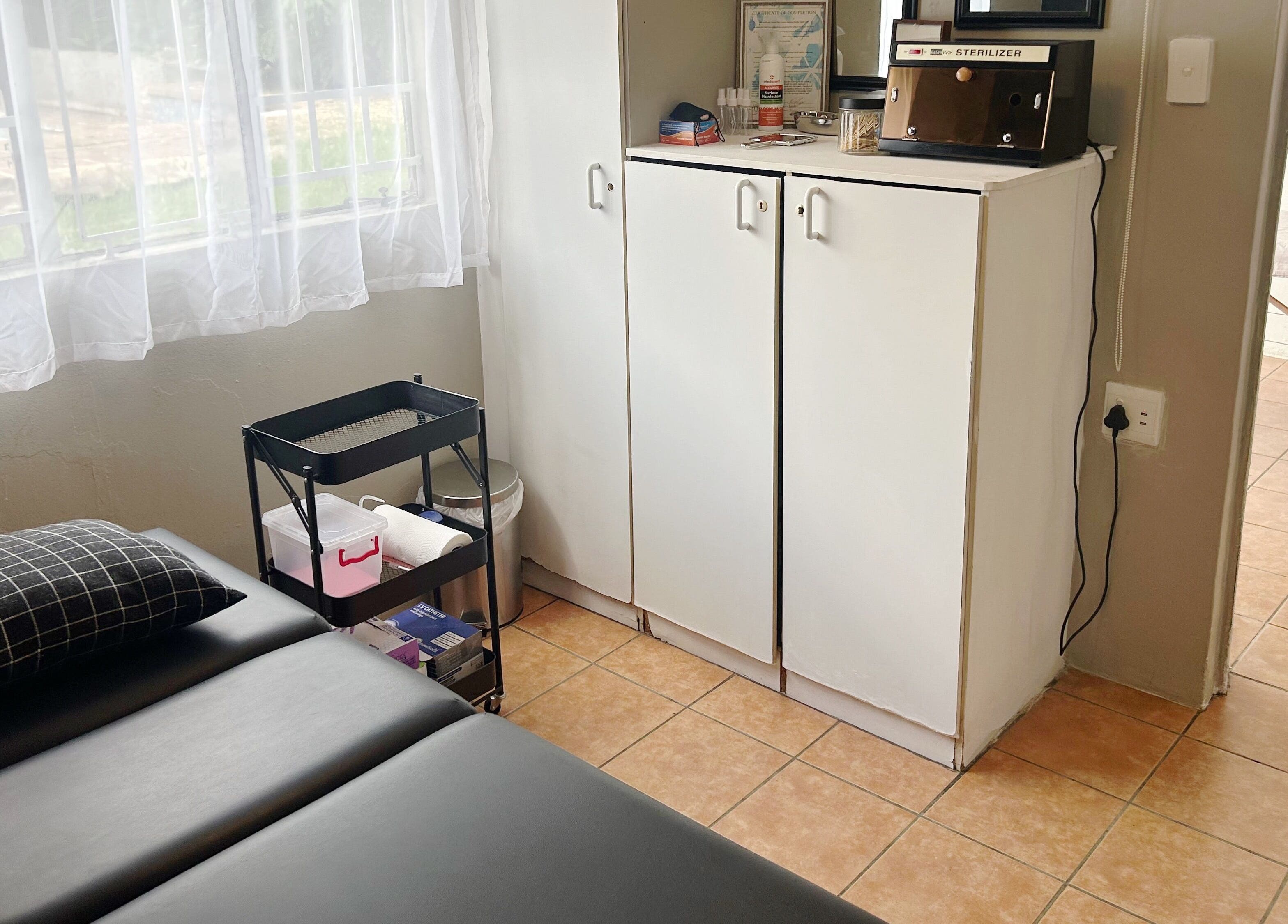 Cozy treatment room at Altered Studio in Edenvale, Gauteng, ZA, featuring a comfortable massage table.