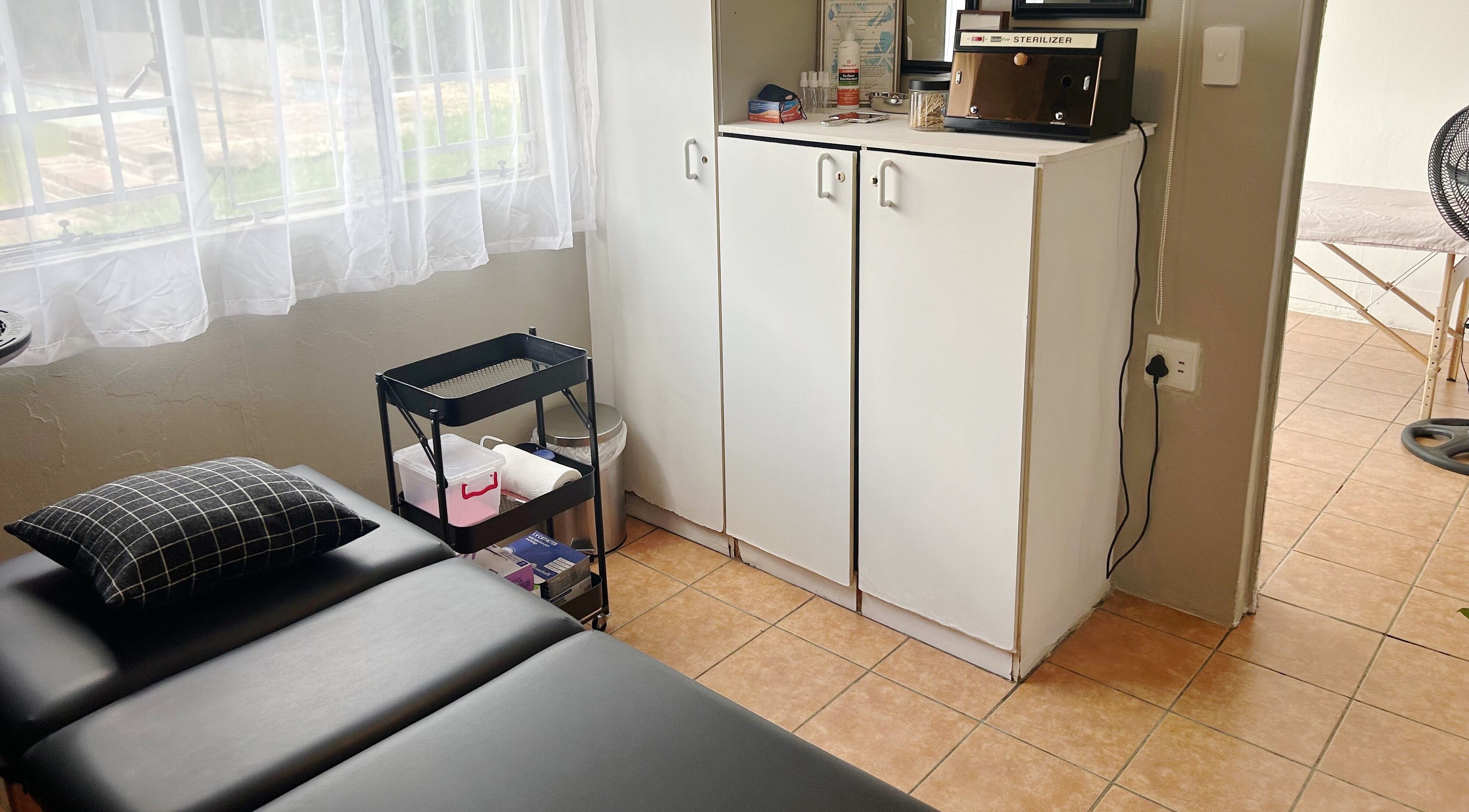 Cozy treatment room at Altered Studio in Edenvale, Gauteng, ZA, featuring a comfortable massage table.