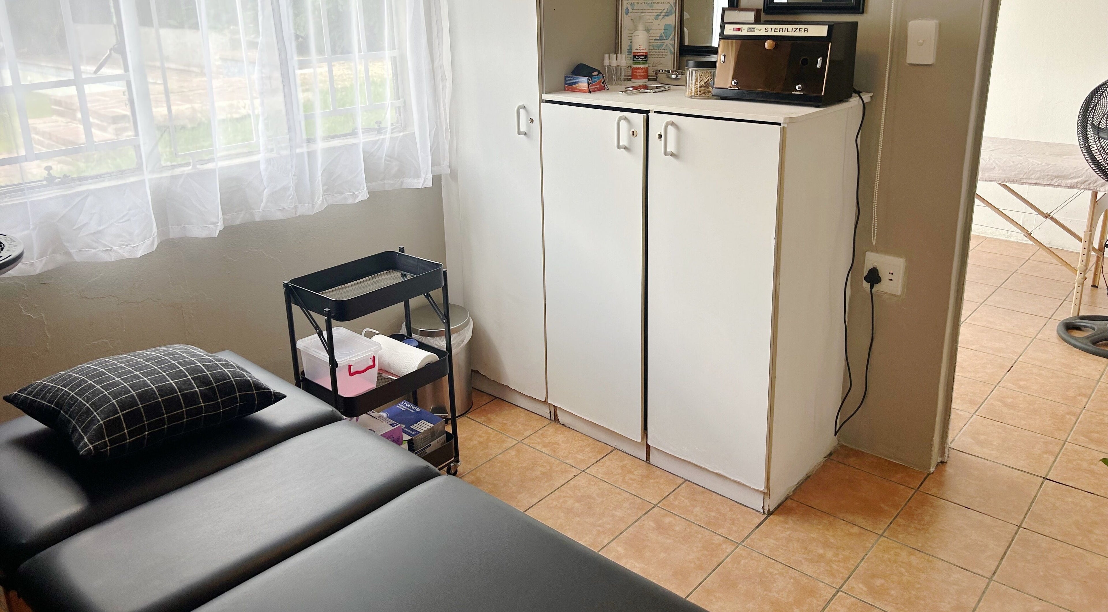 Cozy treatment room at Altered Studio in Edenvale, Gauteng, ZA, featuring a comfortable massage table.