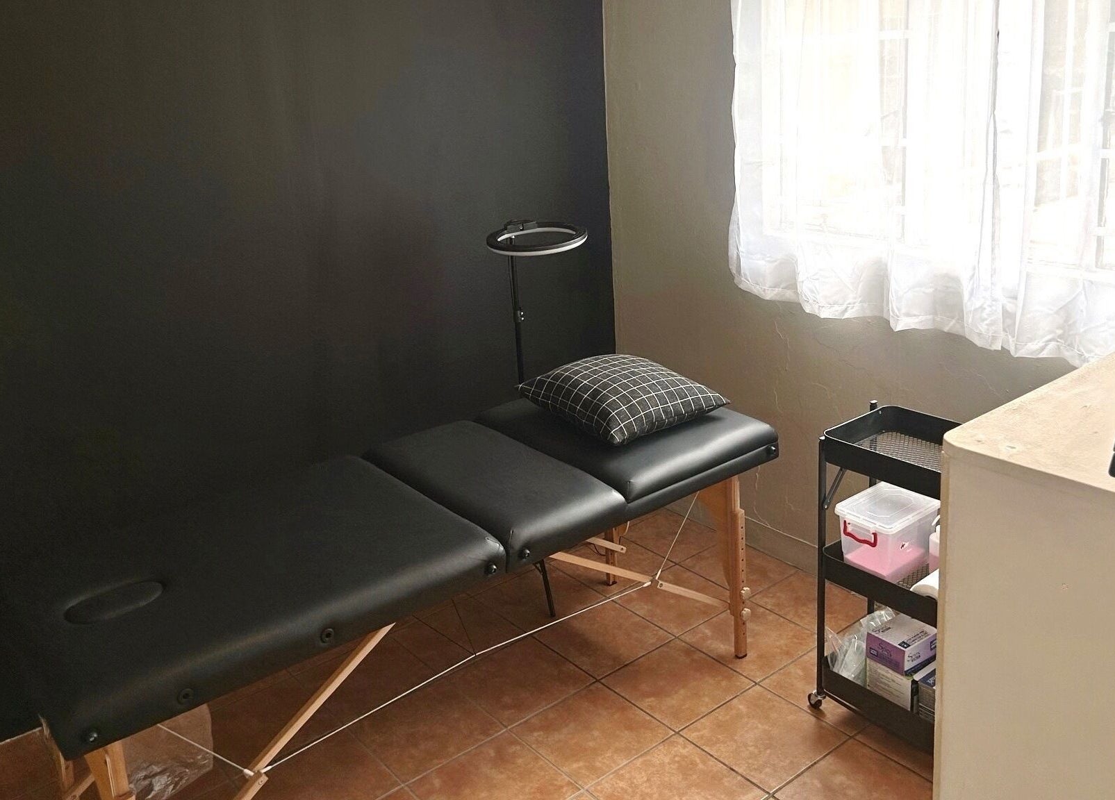 Serene treatment room at Altered Studio, Edenvale, Gauteng, ZA with massage table and natural light.
