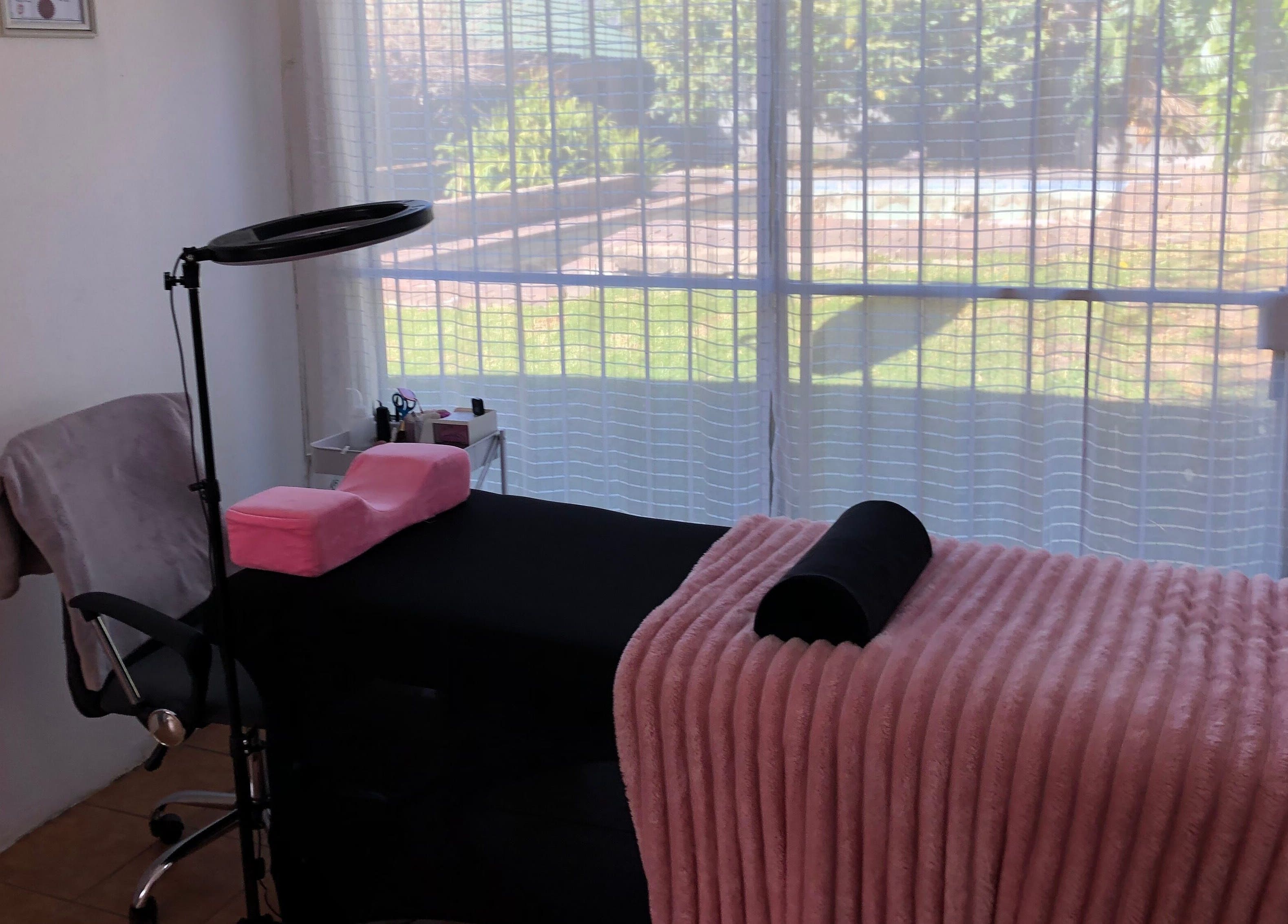 Relaxing beauty treatment room in Altered Studio, Edenvale, Gauteng, ZA, featuring plush pink decor.