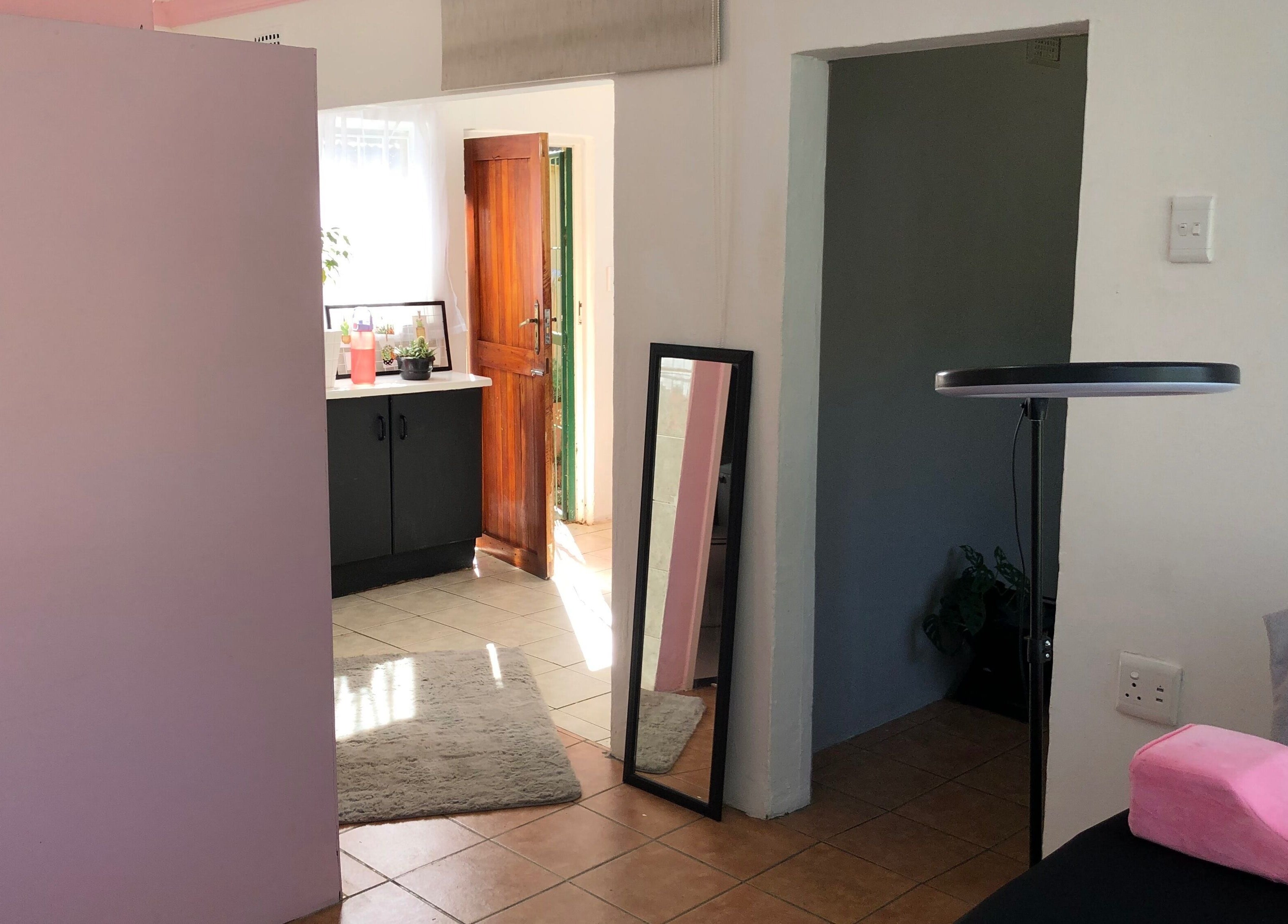 Cozy room at Altered Studio, Edenvale, Gauteng, ZA showcasing a modern mirror and decor.