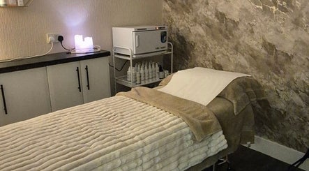 Cozy treatment room at Nicola Hansom Beauty, Ashington, England, GB with plush massage bed and ambient decor.