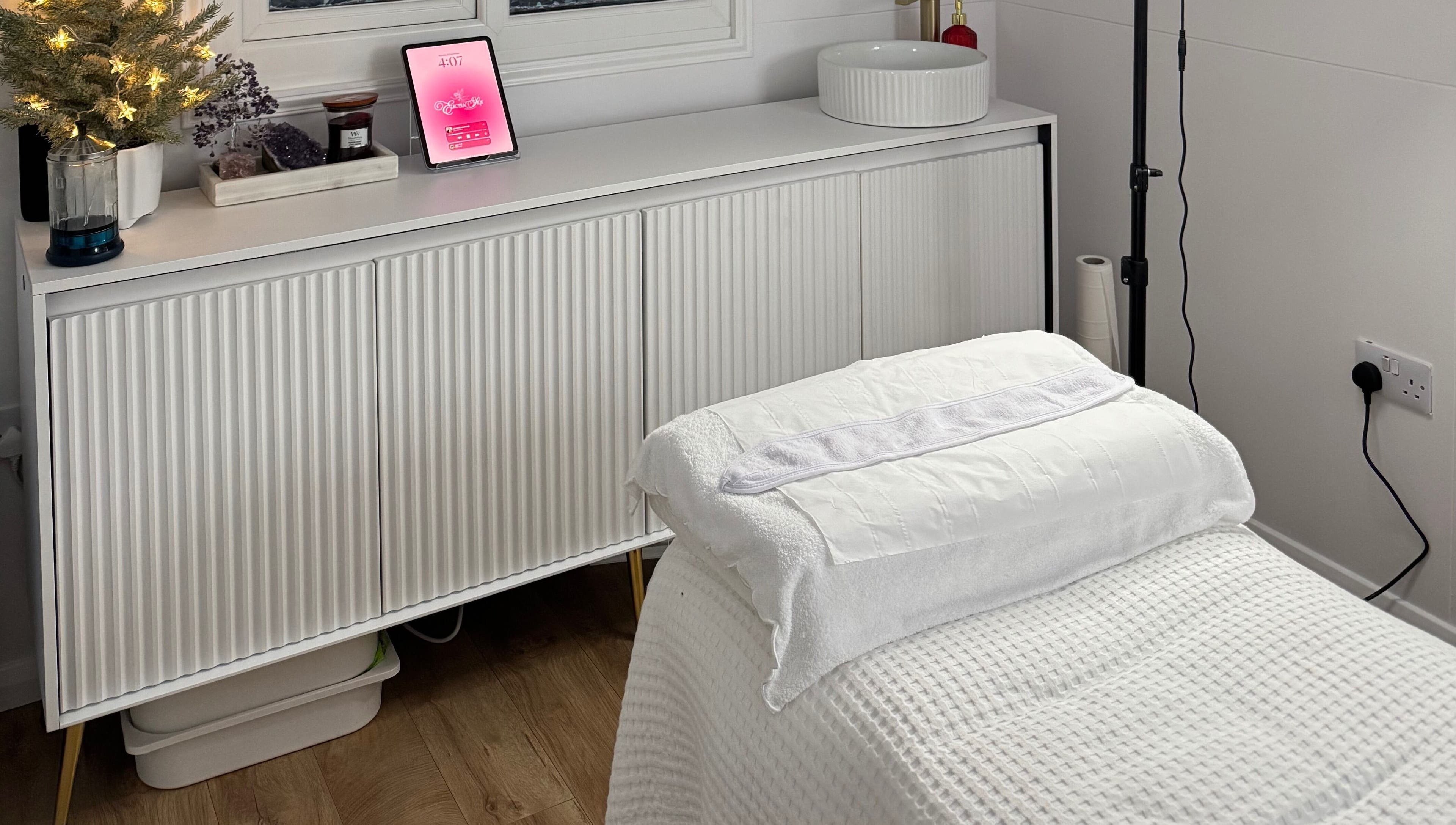Relaxing massage room at Electra Skin in Upton, England, GB with cozy decor and soft lighting.
