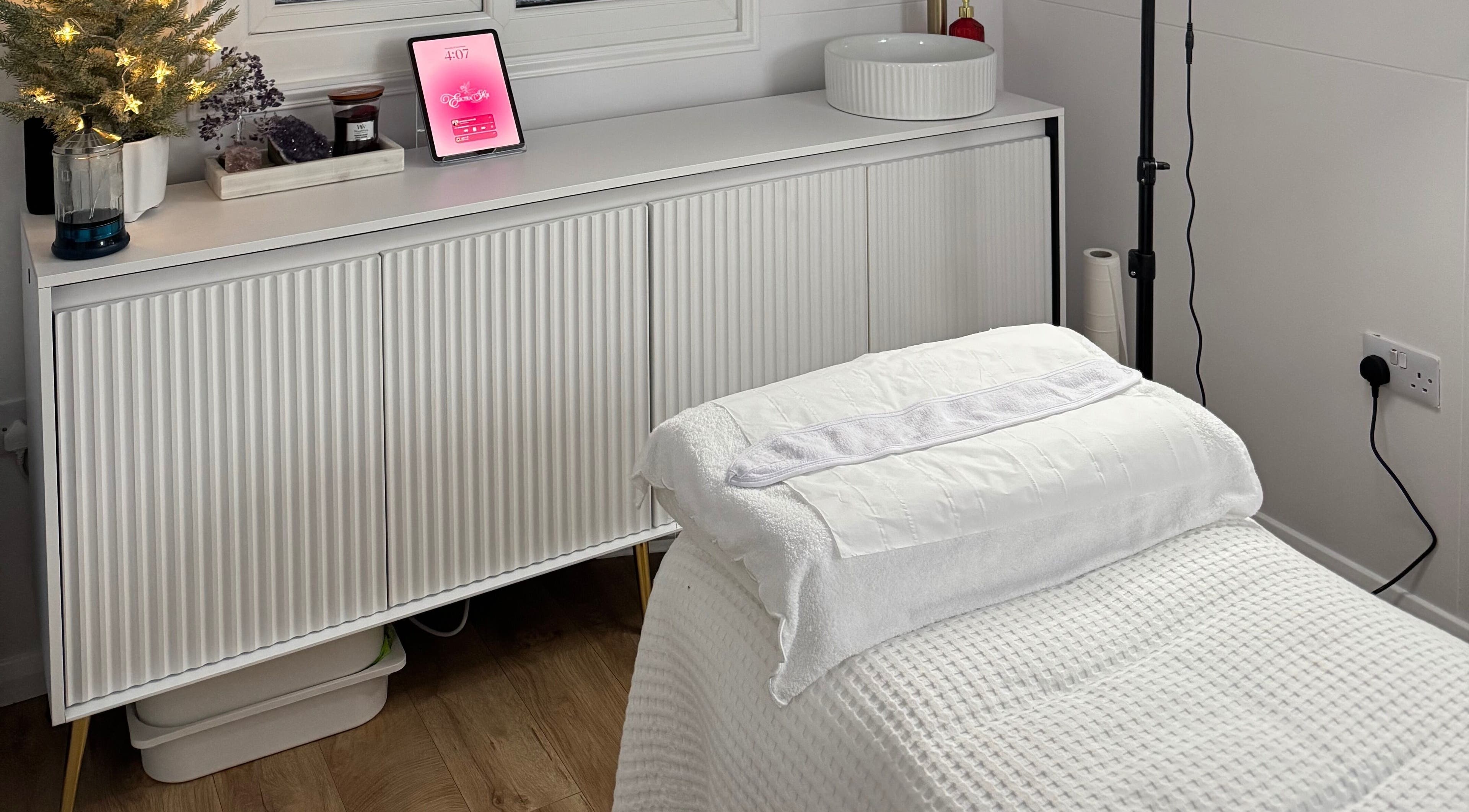 Relaxing massage room at Electra Skin in Upton, England, GB with cozy decor and soft lighting.