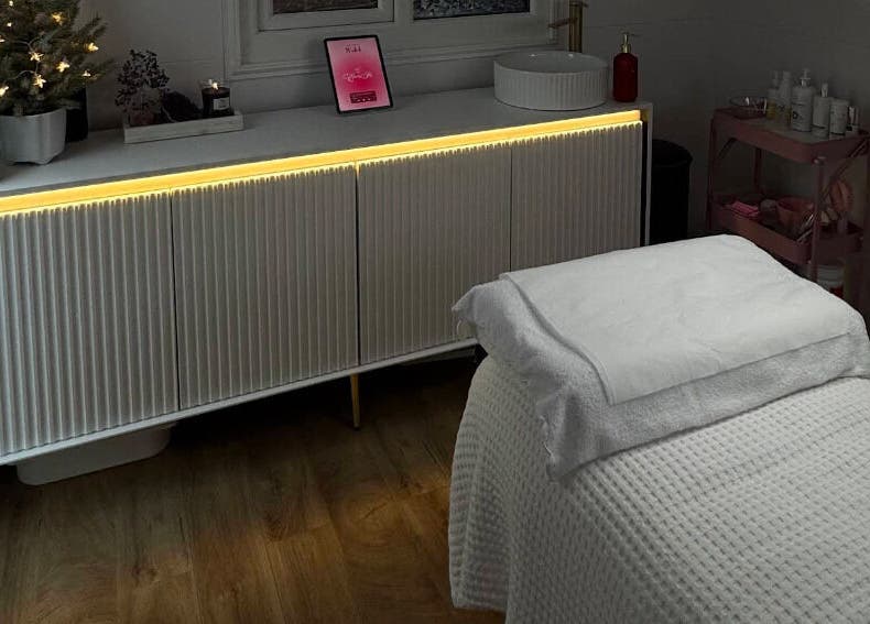 Calm treatment room at Electra Skin, Upton, England, GB, with a cozy bed and ambient lighting.